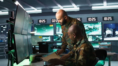 soldier in military hq base doing brainstorming with coworker