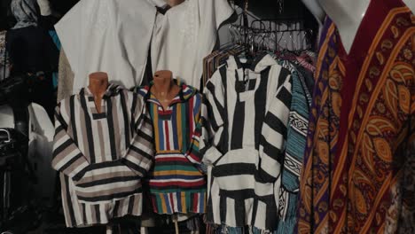 multicolored traditional berbers clothes on a souk in marrakech, morocco. africa