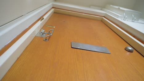 white envelope being dropped through a mail slot in the door