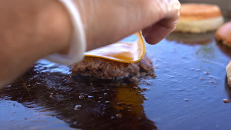 chef-is-cooking-burgers-on-grill