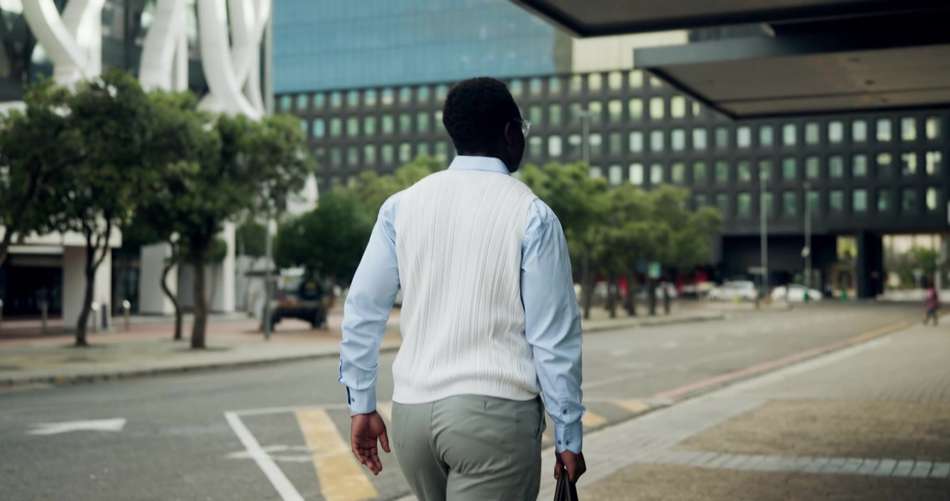 Businessman Walking Down City Street Carrying Briefcase