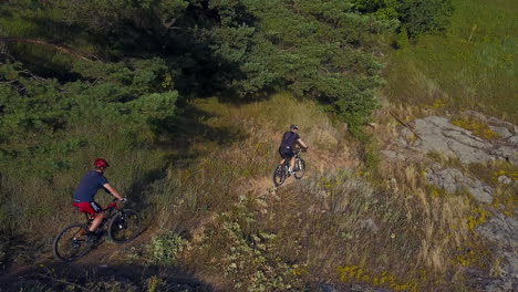 men running on a mountain bike