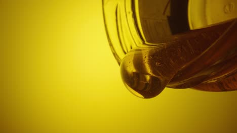 pouring honey into jar