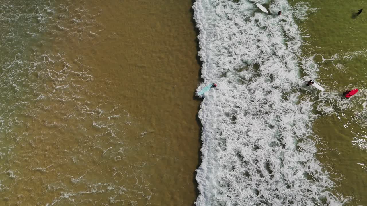 Aerial view of surfers in the ocean
