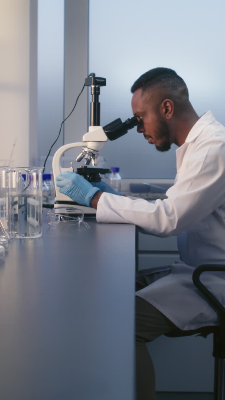 Scientist looking through a microscope in a laboratory
