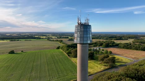 an aerial view of a observation tower on a sunny summer evening