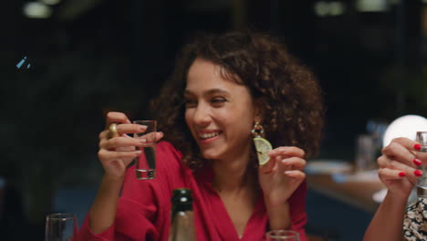 African-american-woman-having-fun-with-friends.-Young-people-drink-shot-in-bar.