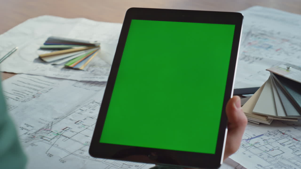 Worker surfing chromakey tablet online at creative studio office closeup