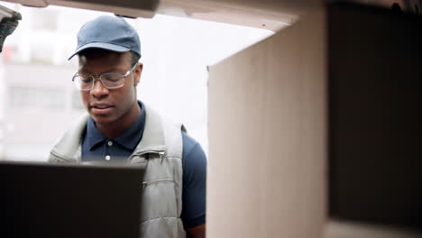 delivery driver checking boxes in a van