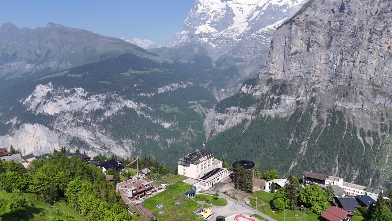 Mountain Village Murren Switzerland Pan up to snow covered mountains aerial