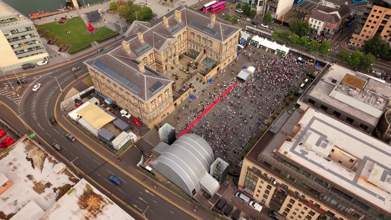 Omvendt 4K 50FPS luftvideo af Custom House Square ved Comhaltas Fleadh Cheoil na hÉireann, Fleadh Belfast 2026. Produceret med Rec709 farve.