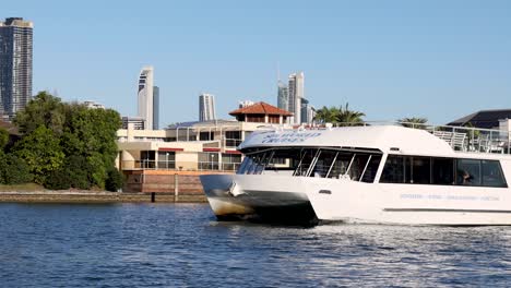 a yacht cruises past waterfront homes