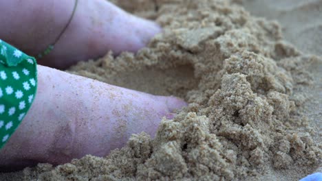 Girl-putting-feet-in-sand