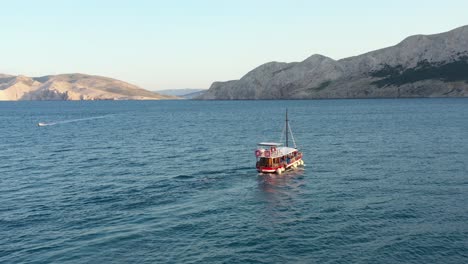 boat sailing on adriatic coast towards the krk island in croatia