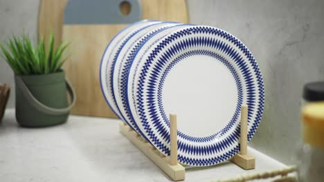 stack of blue and white patterned plates on a wooden stand