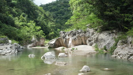 Cinematic-shot-of-latino-man-treading-slowly-through-an-exotic,-wild-scenery