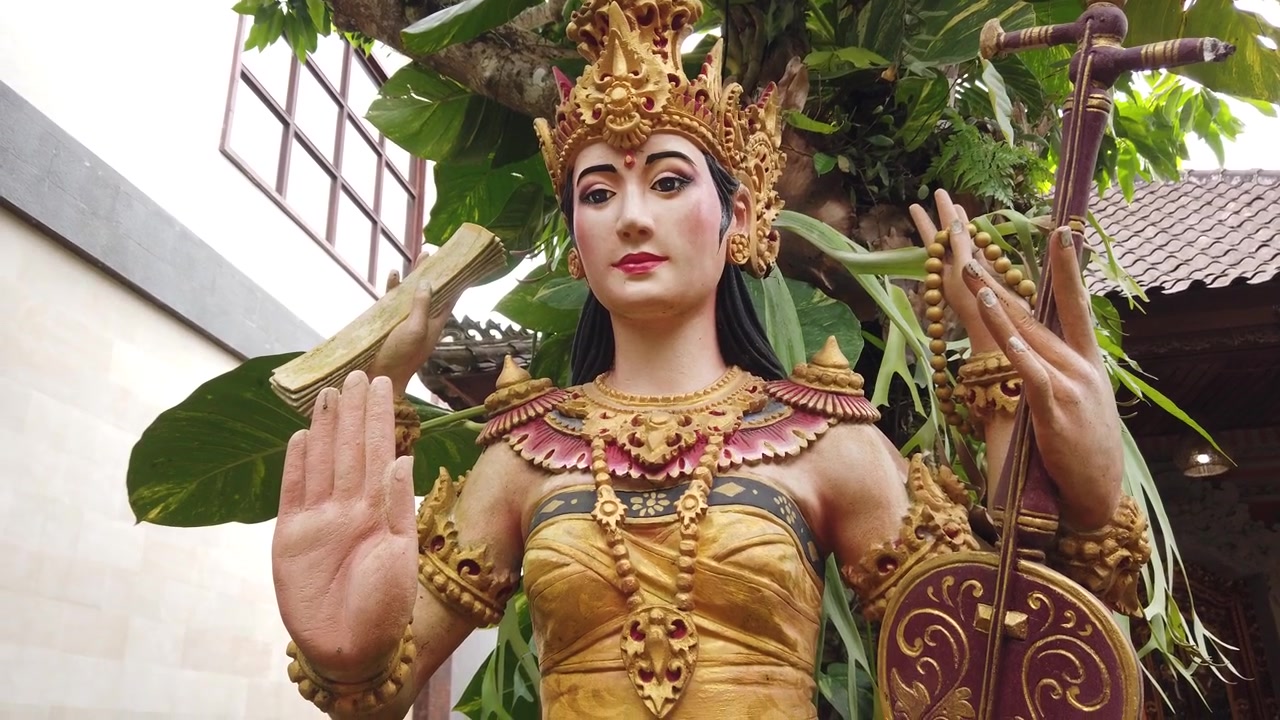 Dewi Saraswati Statue with Rebab Musical instrument Bali Indonesia Ubud, Goddess of Knowledge, Ground Level Close Up View