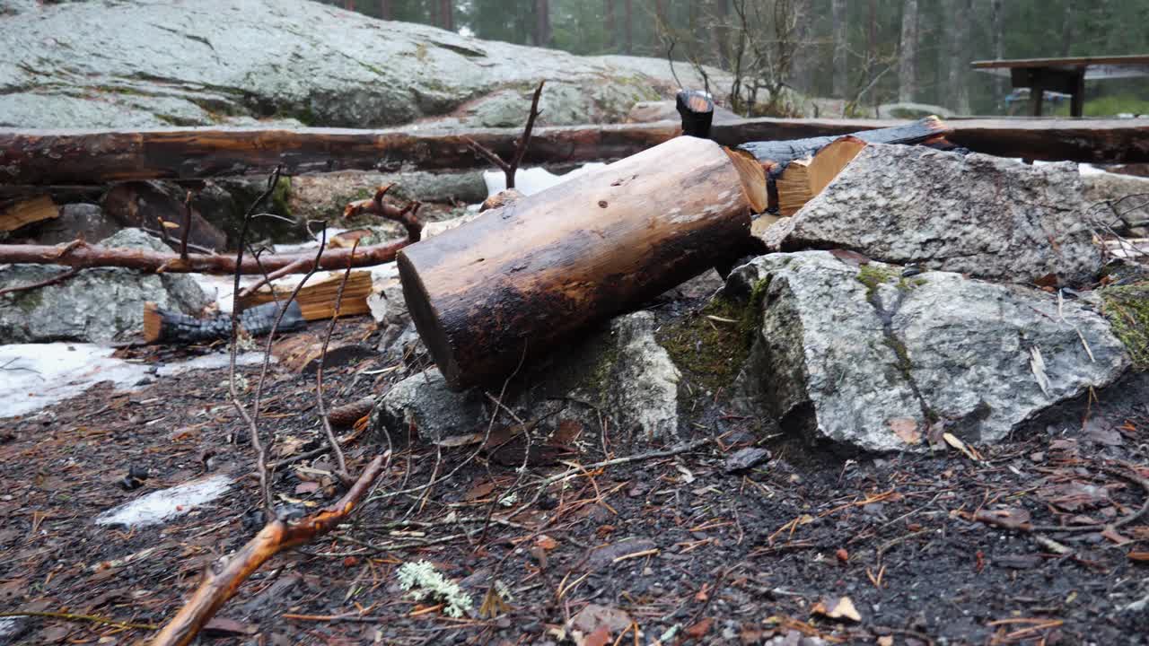 Deserted campsite, fire pit and picnick table area in the forest on a cold and damp day