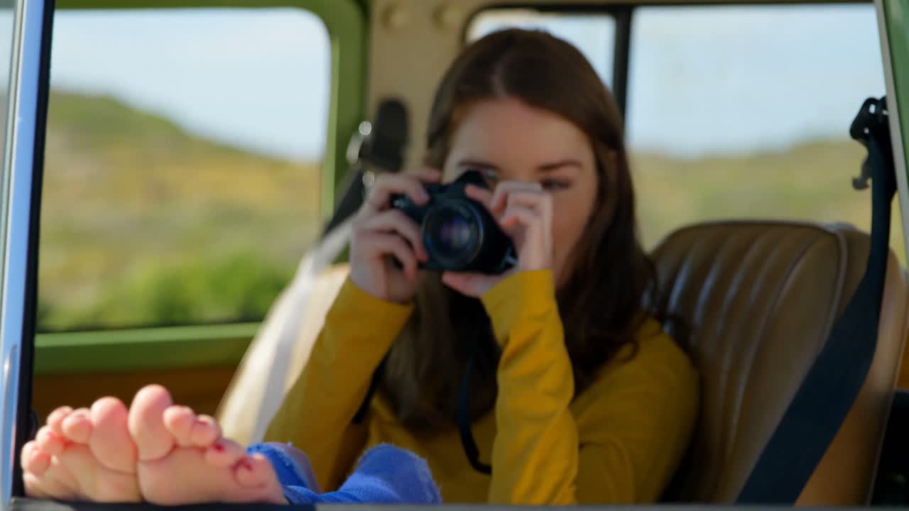 hermosa mujer joven haciendo clic en fotos con cámara digital 4k