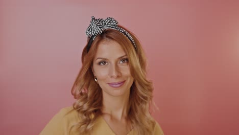 woman with headband in yellow top