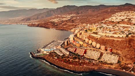 aerial timelapse of radazul, tenerife, golden sunrise illuminates the coastline