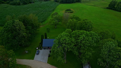 Home-in-the-countryside-at-dusk---pullback-tilt-up-aerial