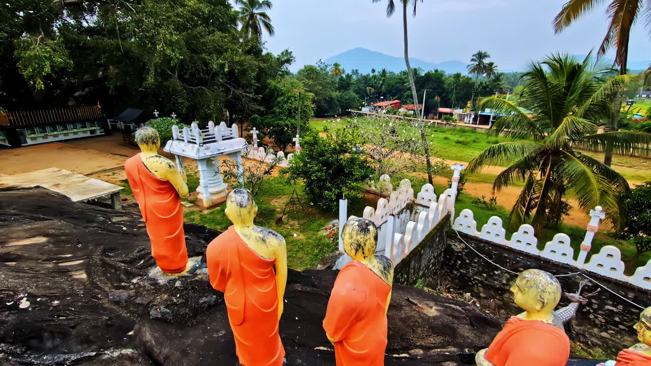 Rows Of Buddhist Monks Statues In Dambulla Cave Temple, World Heritage Site In Sri Lanka. Panning Shot