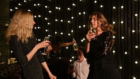 Young-Pretty-Women-Dancing-And-Toasting-With-Champagne-At-A-New-Year's-Eve-Party