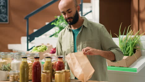 young adult pouring pasta into bag