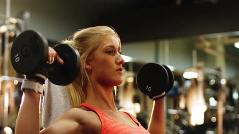 fit woman exercising with dumbbell