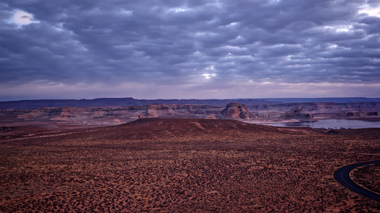 A sweeping aerial view highlighting the rugged and colorful desert terrain near Lake Powell.