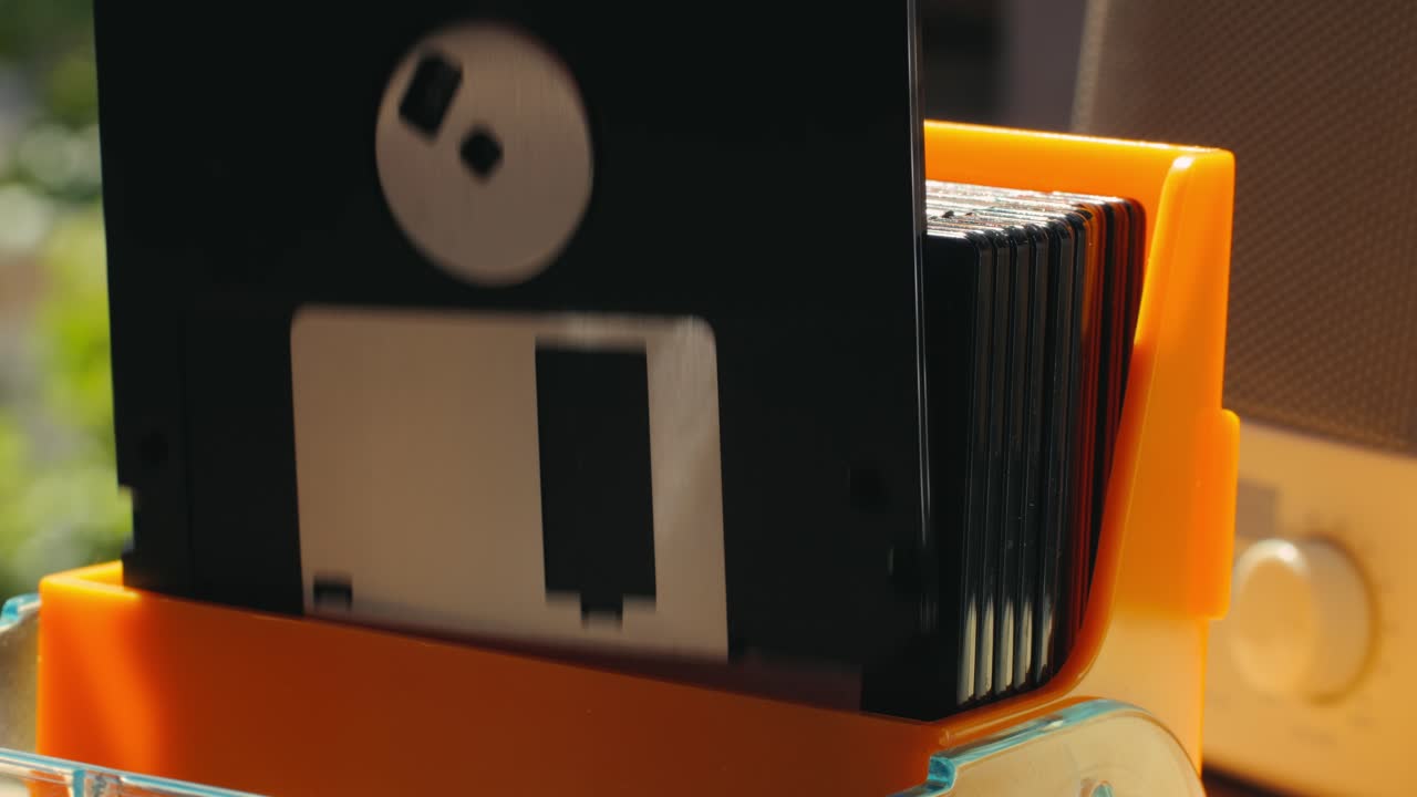 Using diskette for old computer. Music recorder, playing retro computer games. Vintage device for office, obsolete technology. . High quality 4k footage