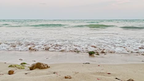 cancun mexico small waves crashing on shore low shot with rocks in the sand of this beautiful beach near tulum