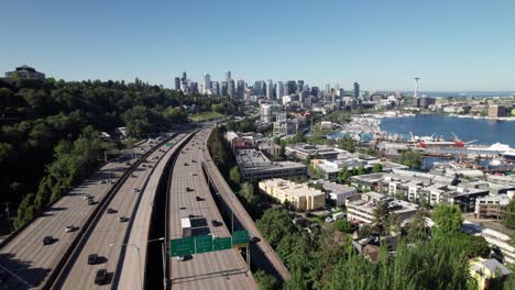 Interstate-traffic-heading-into-downtown-Seattle,-Washington,-aerial-view-with-city-skyline,-4K