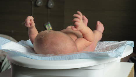 mother checking baby weight with electronic scales