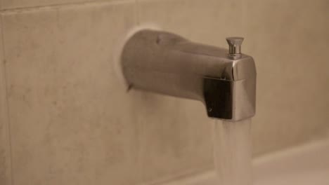 close up of a tap running for a bath