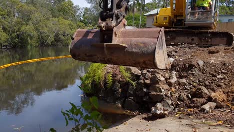 heavy machinery excavating soil and rock on a construction site