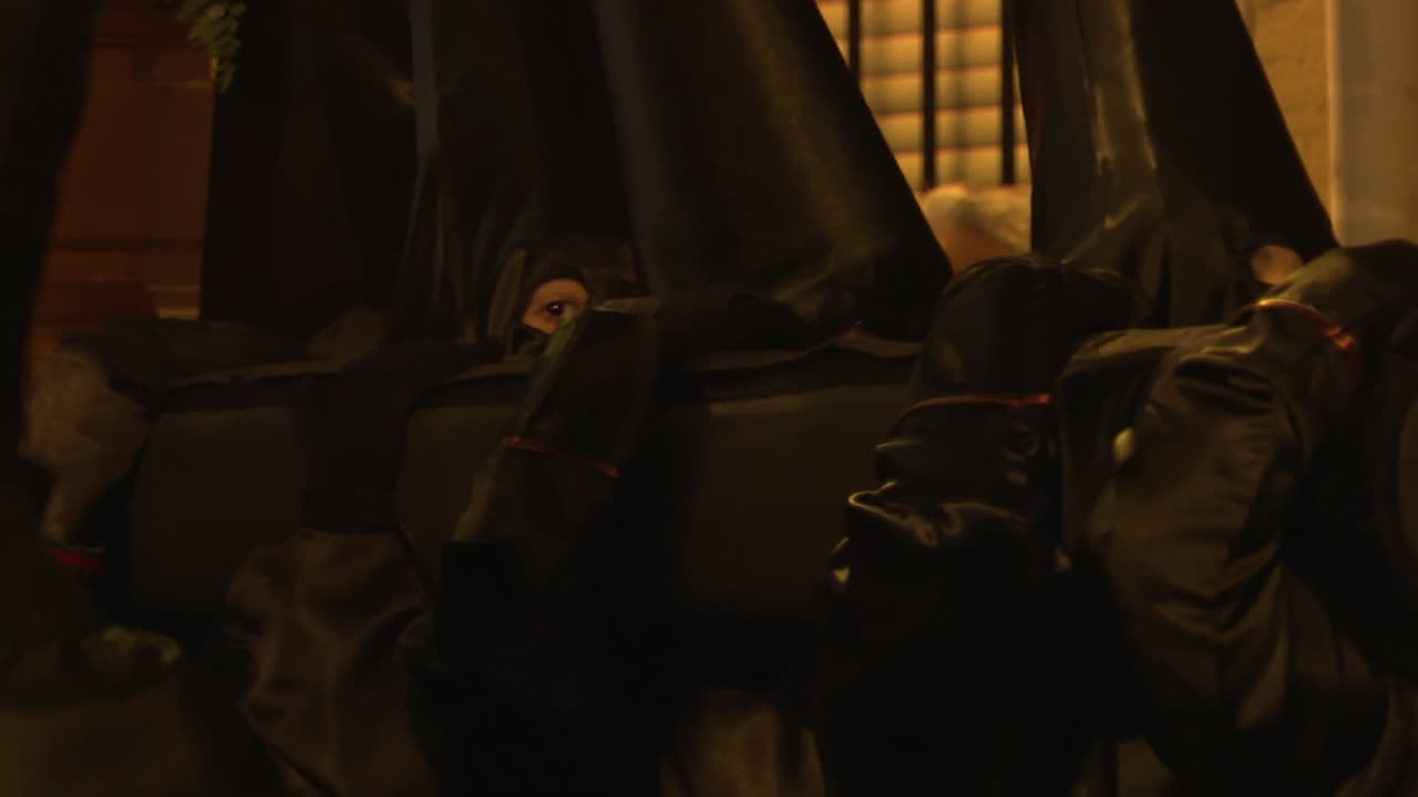 Religious Procession with Penitents in Black Cloaks