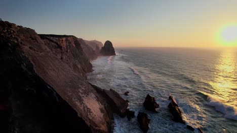 rolling waves on the west coast of portugal during sunset