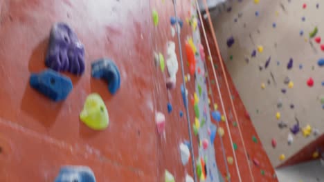 Tensed-woman-hitting-on-wall-during-bouldering-4k