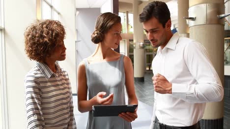 Male-and-female-executives-using-digital-tablet