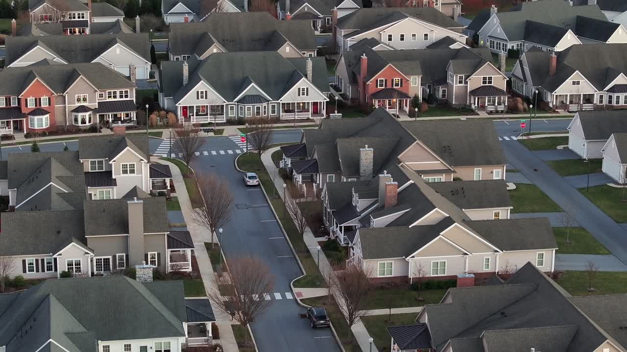 New developed American neighborhood with modern houses and homes in green suburb district of town in Pennsylvania. Cold clear sunset in winter season. Rich Community in suburb.