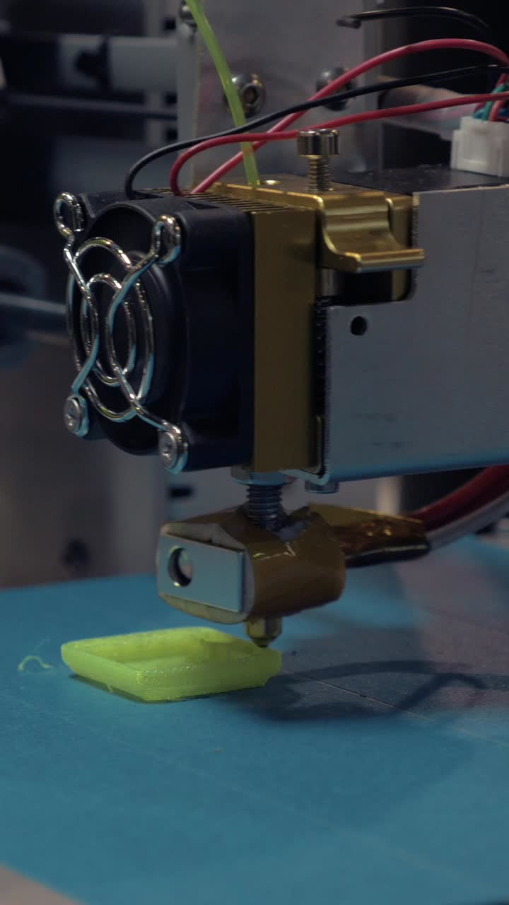 Close-up of a 3D Printer Extruding Green Plastic Filament