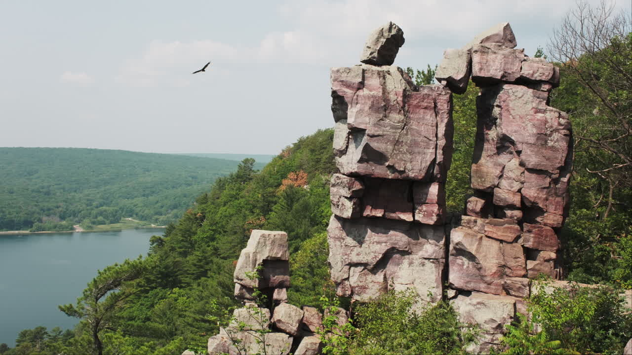 Devil's Doorway Wisconsin rock formation with a hawk soaring above