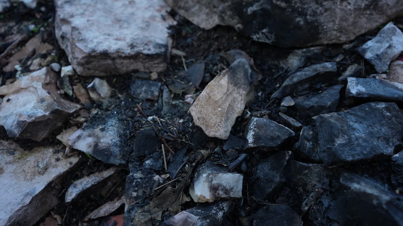Burnt Stones and Ruined Land After Arson Showing Concept of Displacement and Violence on Families
