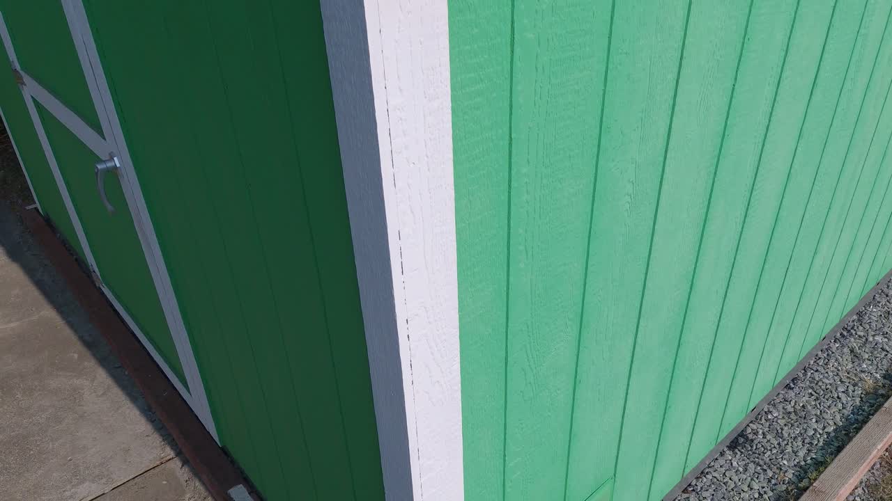 Drone Rise Over Dirty Mini Solar Panels on Backyard Shed