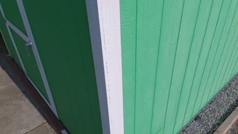 drone rise over dirty mini solar panels on backyard shed