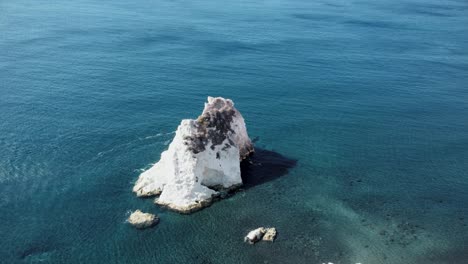 Woman-on-peak-of-White-beach,-Santorini-in-Greece