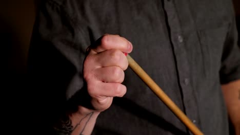 close up of a man wipes a cue with chalk ready to start game. slow motion.