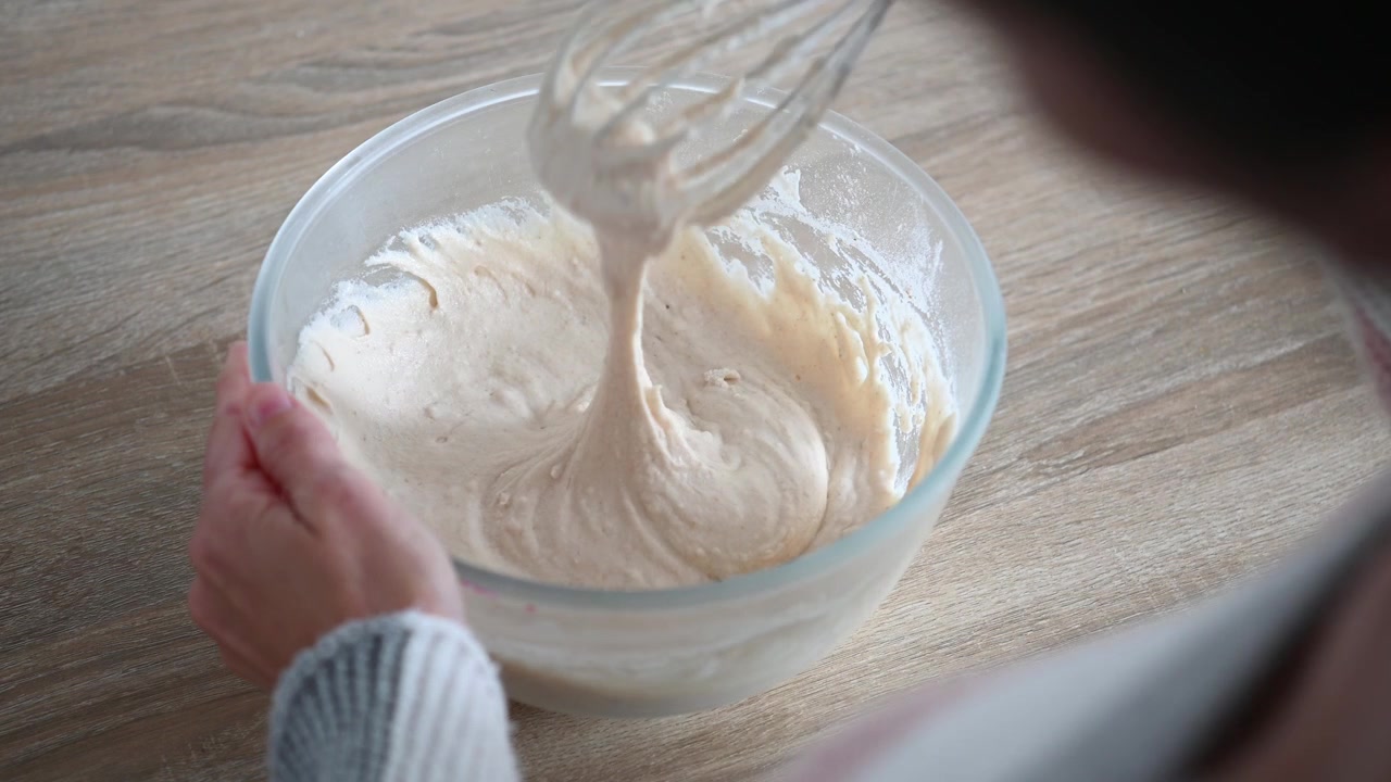 Mixing flour and water to make homemade bread dough
